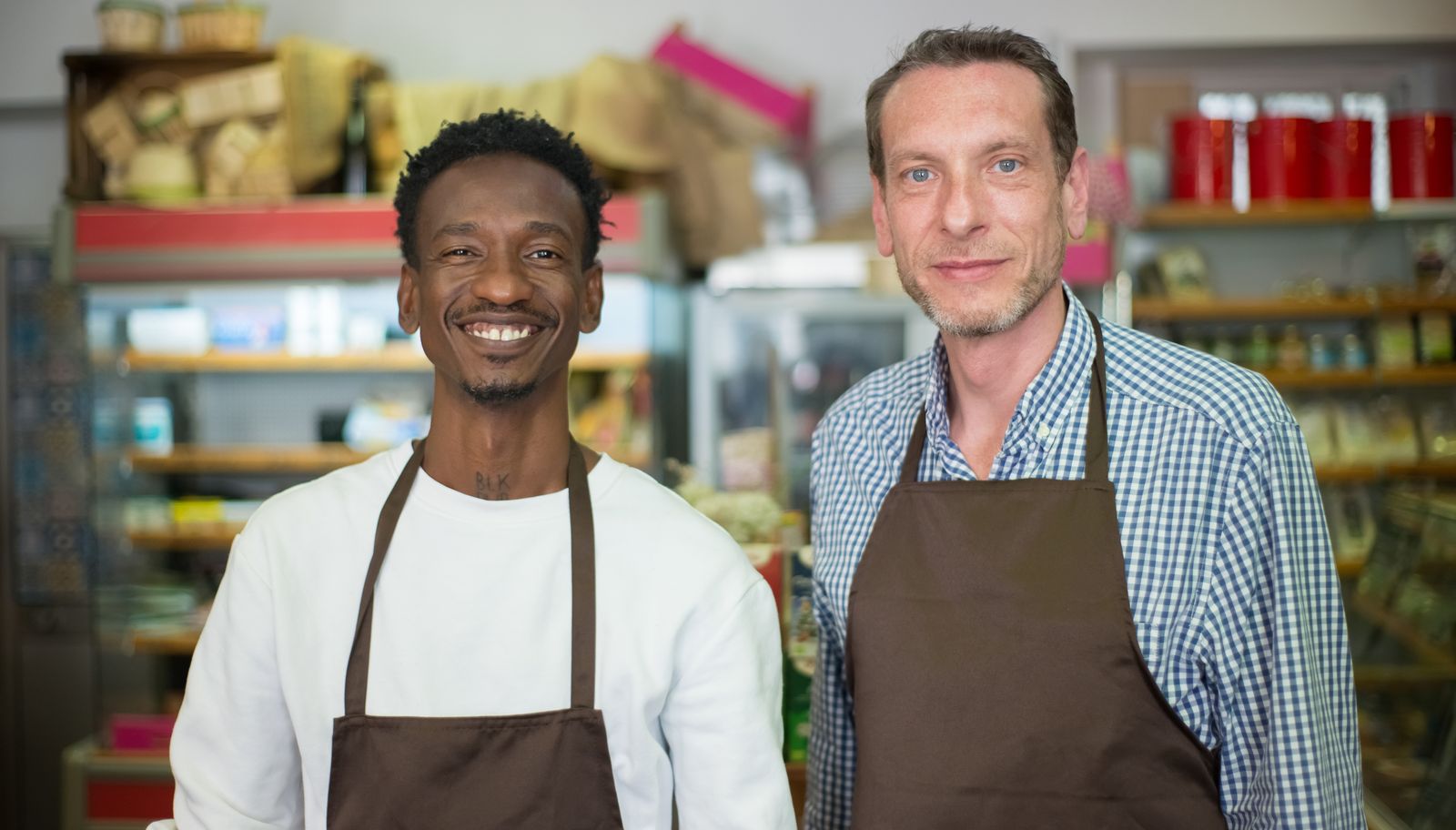 Two local business owners standing together inside their shop