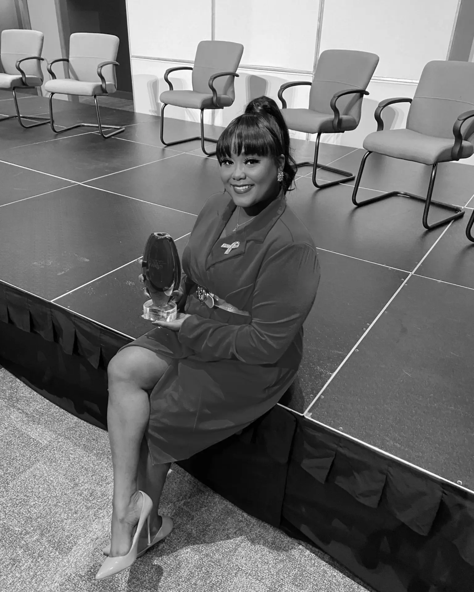 Candice Cohen holding an industry award after a speaking engagement